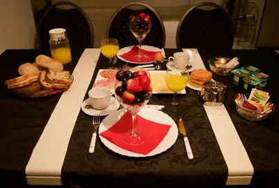 a table topped with glasses of orange juice and bread at The Studio Guesthouse in Volendam