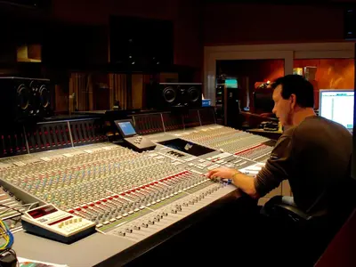 a man sitting at a mixing desk in a recording studio at The Studio Guesthouse in Volendam