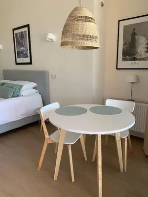 a white table and chairs in a room with a bed at Waterfront Studio in Amsterdam