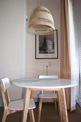 a table and chairs in a room with a lamp at Waterfront Studio in Amsterdam