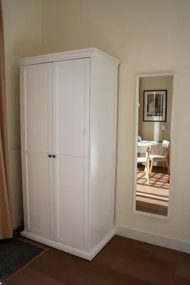 a white cabinet in a room with a mirror at Waterfront Studio in Amsterdam