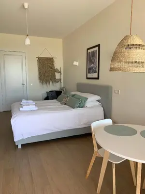 a bedroom with a bed and a table in it at Waterfront Studio in Amsterdam