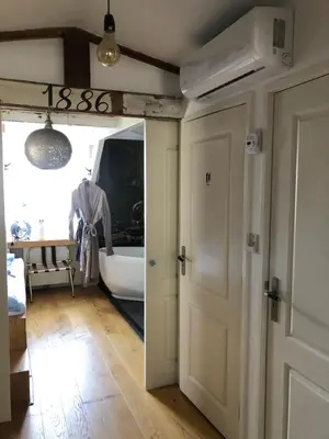 a bathroom with a door leading to a bath tub at B&B Numero 14 in Amsterdam
