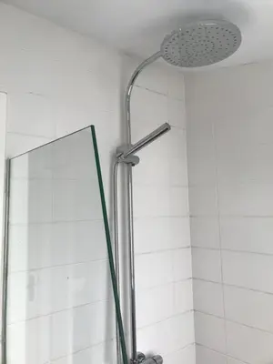 a shower with a shower head and a mirror at B&B Numero 14 in Amsterdam