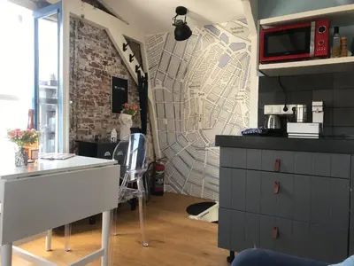 a kitchen with a white counter and a wall at B&B Numero 14 in Amsterdam
