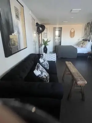 a living room with a couch and a table at B&B Zeespiegel in Zandvoort