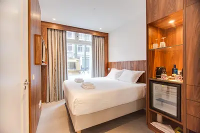 a hotel room with a bed and a window at Het Kabinet in Amsterdam