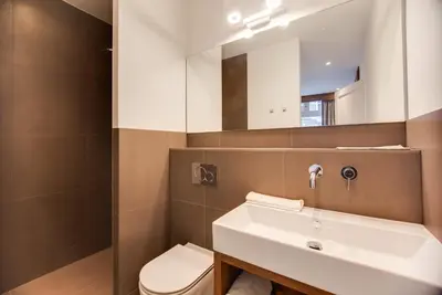 a bathroom with a sink and a toilet and a mirror at Het Kabinet in Amsterdam