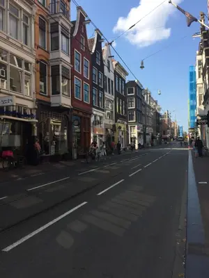 an empty street in a city with buildings at Het Kabinet in Amsterdam
