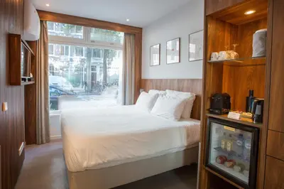 a hotel room with a bed and a window at Het Kabinet in Amsterdam