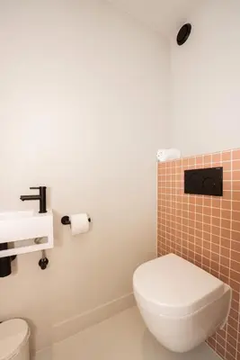 a bathroom with a toilet and a sink at Poort Beach Boutique Apartments in Bloemendaal Aan Zee