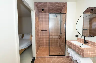 a bathroom with a shower and a sink at Poort Beach Boutique Apartments in Bloemendaal Aan Zee