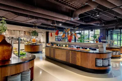 a restaurant with a counter with food on it at Corendon Urban Amsterdam Schiphol Airport Hotel in Badhoevedorp