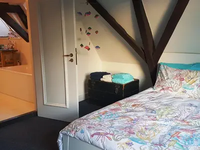 a bedroom with a bed and a bath tub at Large Historical Apartment & Canal Terrace in Utrecht