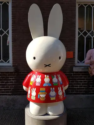 a statue of a rabbit wearing a red shirt at Large Historical Apartment & Canal Terrace in Utrecht