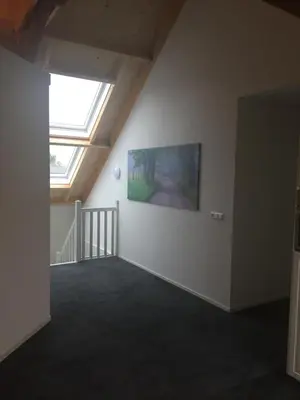 an empty room with a window and a painting on the wall at Appartementen Rijnhoeve in Koudekerk aan den Rijn