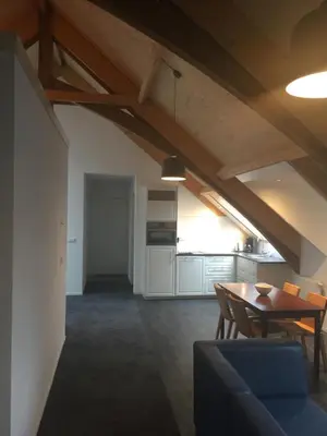 a living room with a table and a kitchen at Appartementen Rijnhoeve in Koudekerk aan den Rijn
