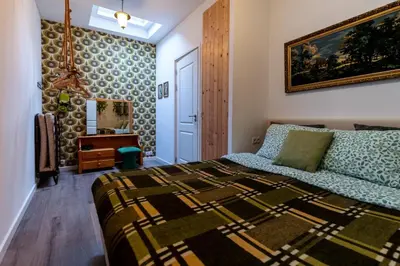 a bedroom with a bed and a painting on the wall at SOEPP hotel & restaurant in Alkmaar