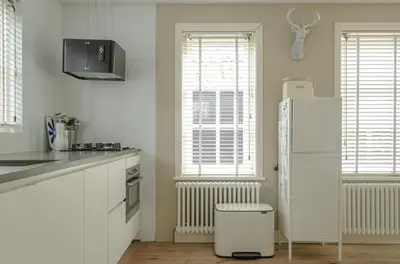 a kitchen with a white refrigerator and a window at Minime in Bergen