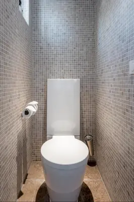 a bathroom with a white toilet in a tiled room at Minime in Bergen