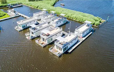 an aerial view of a row of houses in the water at Aquacabin in Aalsmeer