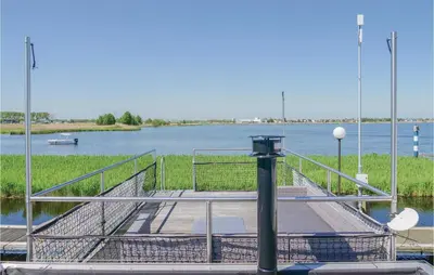 a dock with a walkway on a body of water at Aquacabin in Aalsmeer