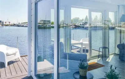 a house with a balcony with a view of the water at Aqualiving in Aalsmeer