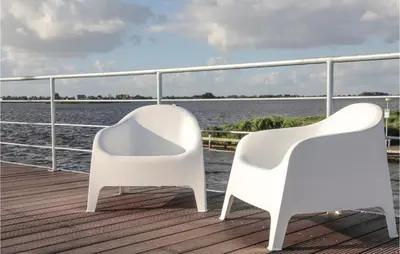 two white chairs sitting on the deck of a boat at Aqualiving in Aalsmeer