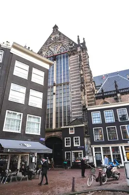a group of buildings with people walking in front of them at Hotel Corner House in Amsterdam