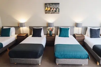a room with two beds with blue pillows at Hotel Corner House in Amsterdam