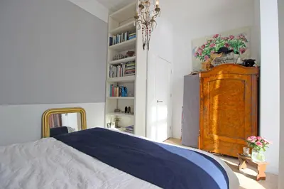 a bedroom with a bed and a wooden dresser at Vondelpark Suite in Amsterdam
