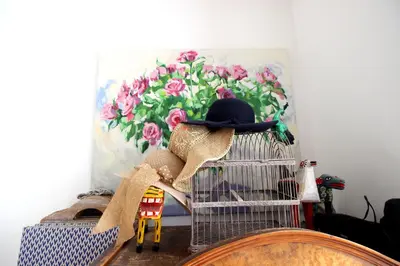 a bird cage with a hat on top of it at Vondelpark Suite in Amsterdam