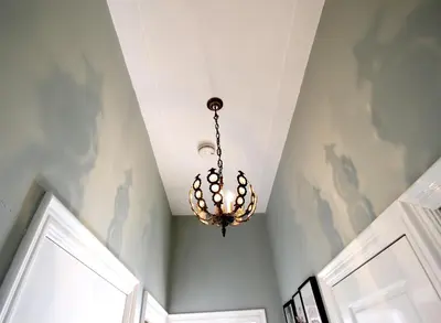 a chandelier hanging from a ceiling in a room at Vondelpark Suite in Amsterdam