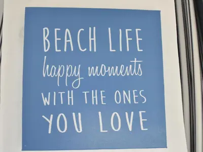 a sign that says beach life happy moments with the ones you love at Holiday Home Bergen aan Zee near Beach in Bergen aan Zee