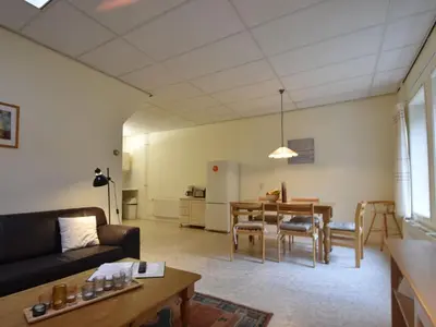 a living room with a couch and a table at Apartment Bergen aan Zee near Beach in Bergen aan Zee