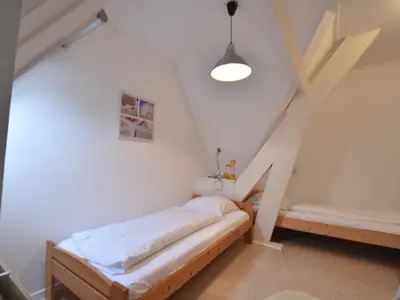 a small room with a bed and stairs at Apartment Bergen aan Zee near Beach in Bergen aan Zee