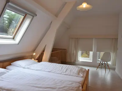 a bedroom with two beds and a window at Apartment Bergen aan Zee near Beach in Bergen aan Zee