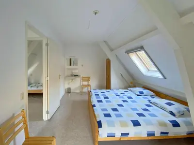 a bedroom with a bed in a attic at Apartment Bergen aan Zee near Beach in Bergen aan Zee