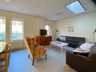 a living room with a couch and a table at Apartment Bergen aan Zee near Beach in Bergen aan Zee