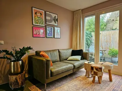 a living room with a couch and a table at Zandvoort at Home I Free parking & Airco in Zandvoort