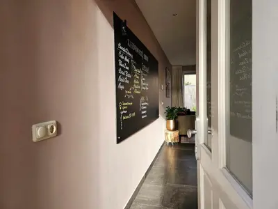 a hallway with a chalkboard on the wall and a hallway sidx sidx at Zandvoort at Home I Free parking & Airco in Zandvoort