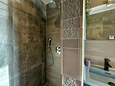 a bathroom with a shower with a glass door at Zandvoort at Home I Free parking & Airco in Zandvoort