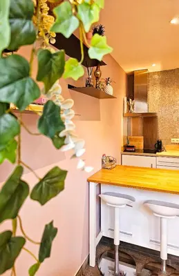 a kitchen with a counter and two stools at Zandvoort at Home I Free parking & Airco in Zandvoort