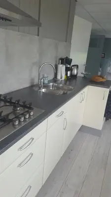 a kitchen with a sink and a counter top at B&B Beemsterlust in Westbeemster