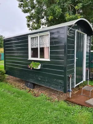a green trailer with a window and a flower pot at B&B Beemsterlust in Westbeemster