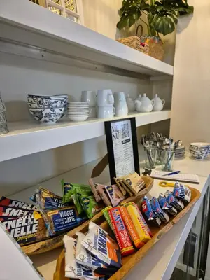 a shelf with chips and other snacks on it at Boutique Hotel De Raetskamer in Noordwijkerhout