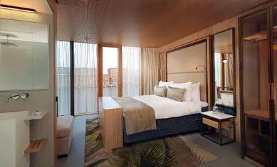 a hotel room with a bed and a bathroom at Hotel Jakarta Amsterdam in Amsterdam
