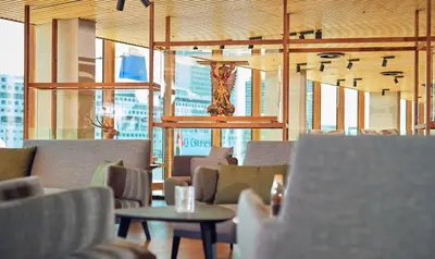 a restaurant with chairs and a vase on the ceiling at Hotel Jakarta Amsterdam in Amsterdam