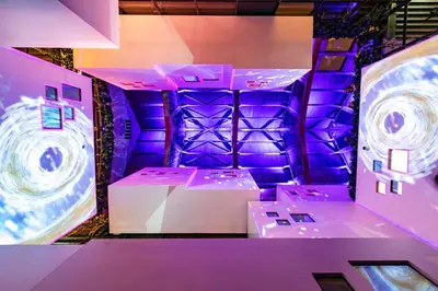 a room with purple lighting and a stage at Bunk Hotel Amsterdam in Amsterdam