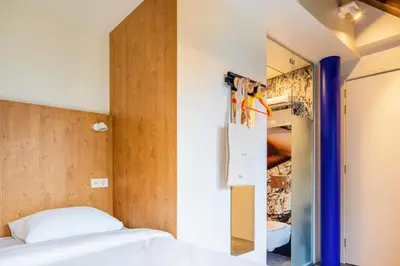 a bedroom with a bed and a closet at Bunk Hotel Amsterdam in Amsterdam